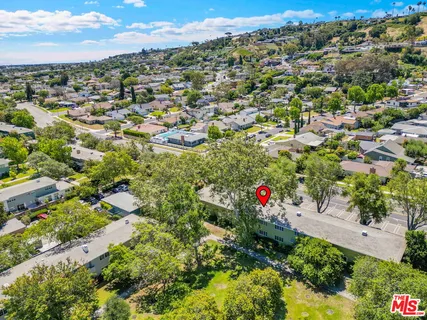 an aerial view of residential houses with outdoor space