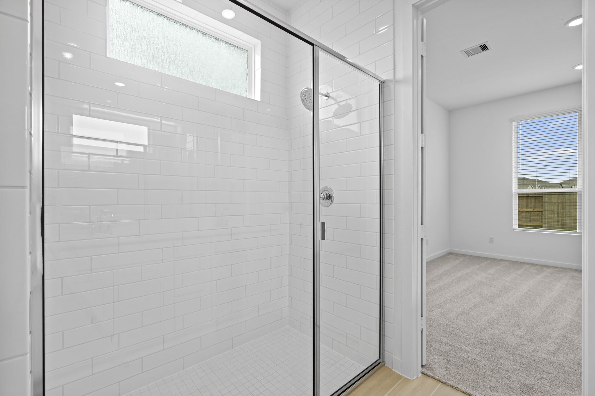 2720 Grove Crest Drive Rosenberg, TX 77469 - Photo 20 of 32 Elegant walk-in shower with sleek subway tile surround, frameless glass enclosure, and abundant natural light.