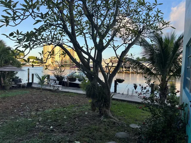 a view of a house with large trees