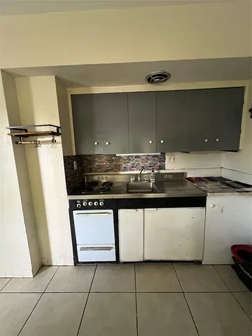 a room with furniture a flat screen tv and a window