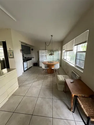 a view of kitchen with furniture and electronic appliances