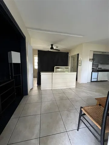 a living room with furniture a flat screen tv and a window