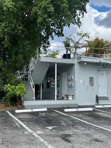 front view of a house with a potted plant