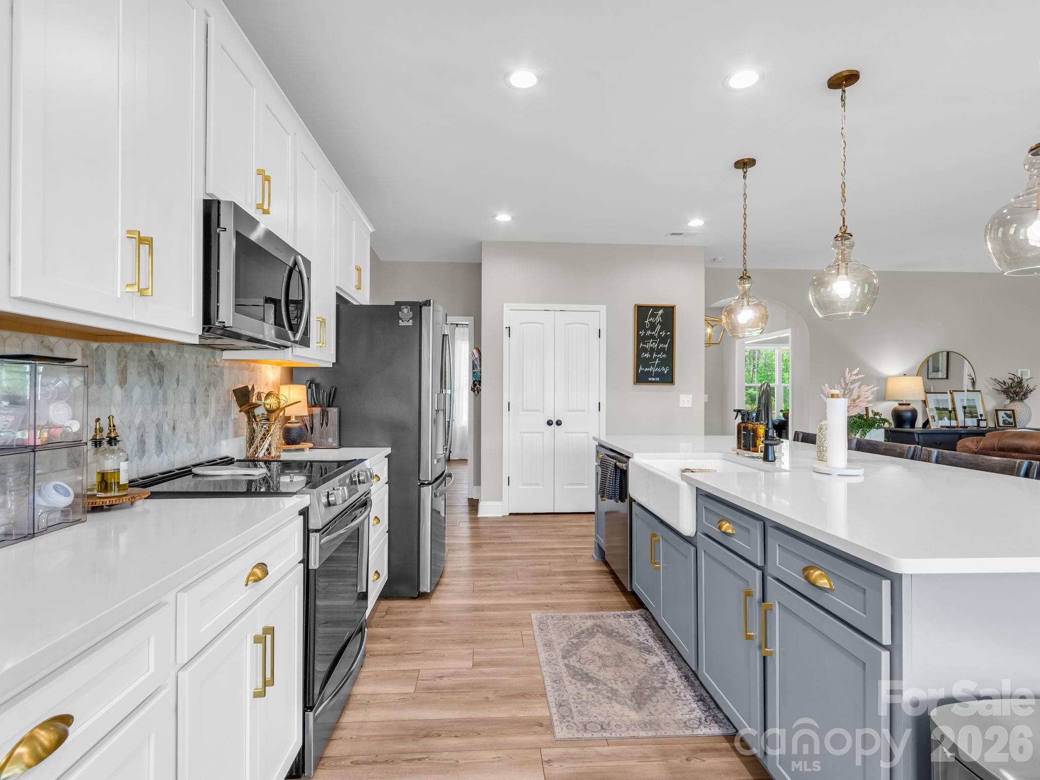 288 Maypole Court Forest City, NC 28043 - Photo 11 of 47 a large kitchen with stainless steel appliances granite countertop a stove a sink and a refrigerator