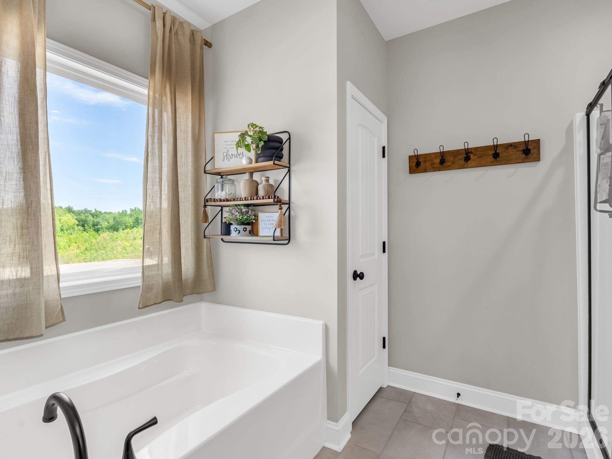 288 Maypole Court Forest City, NC 28043 - Photo 20 of 47 a bathroom with a tub and a window