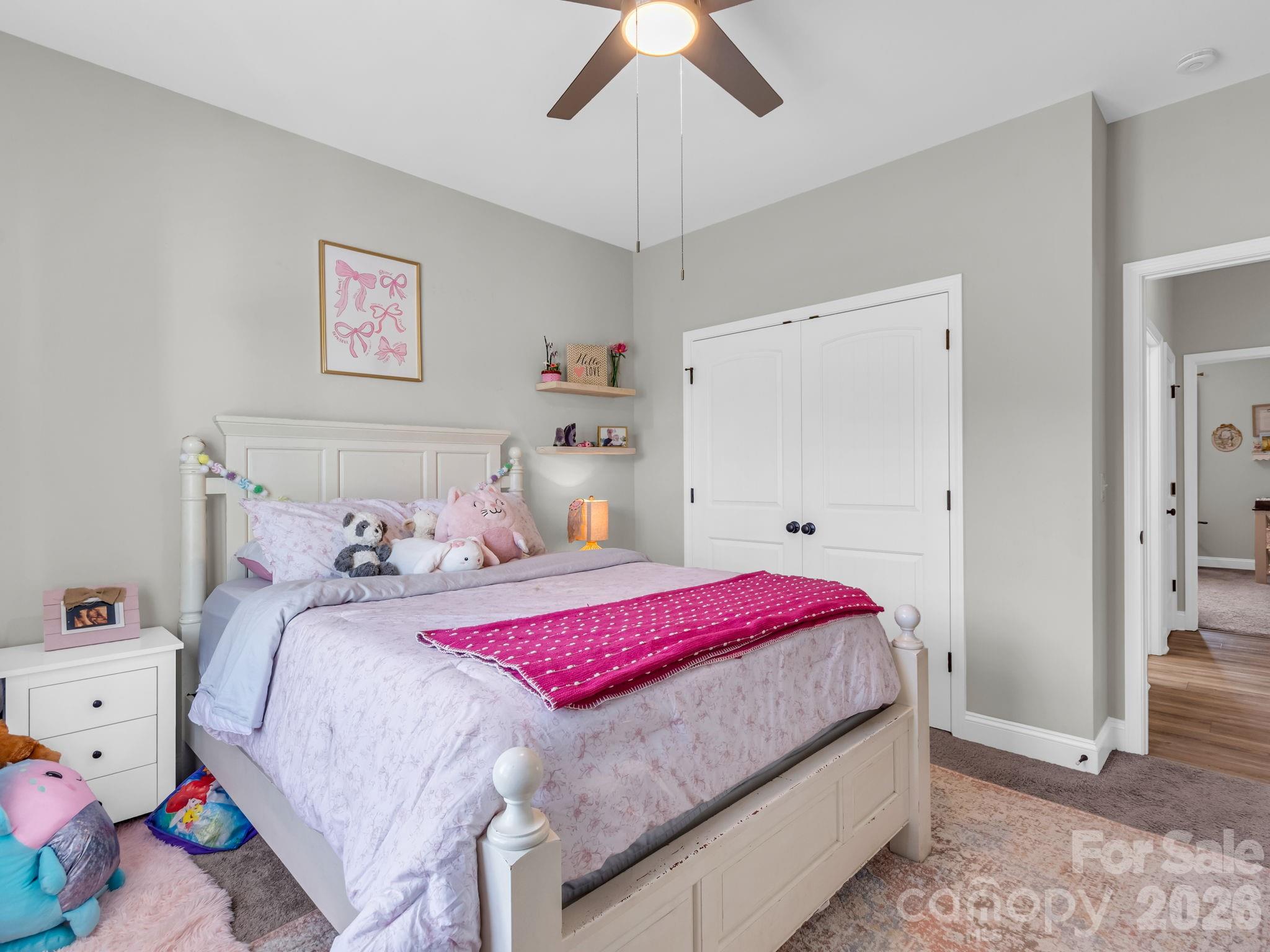 288 Maypole Court Forest City, NC 28043 - Photo 28 of 47 a bedroom with a bed and a chandelier