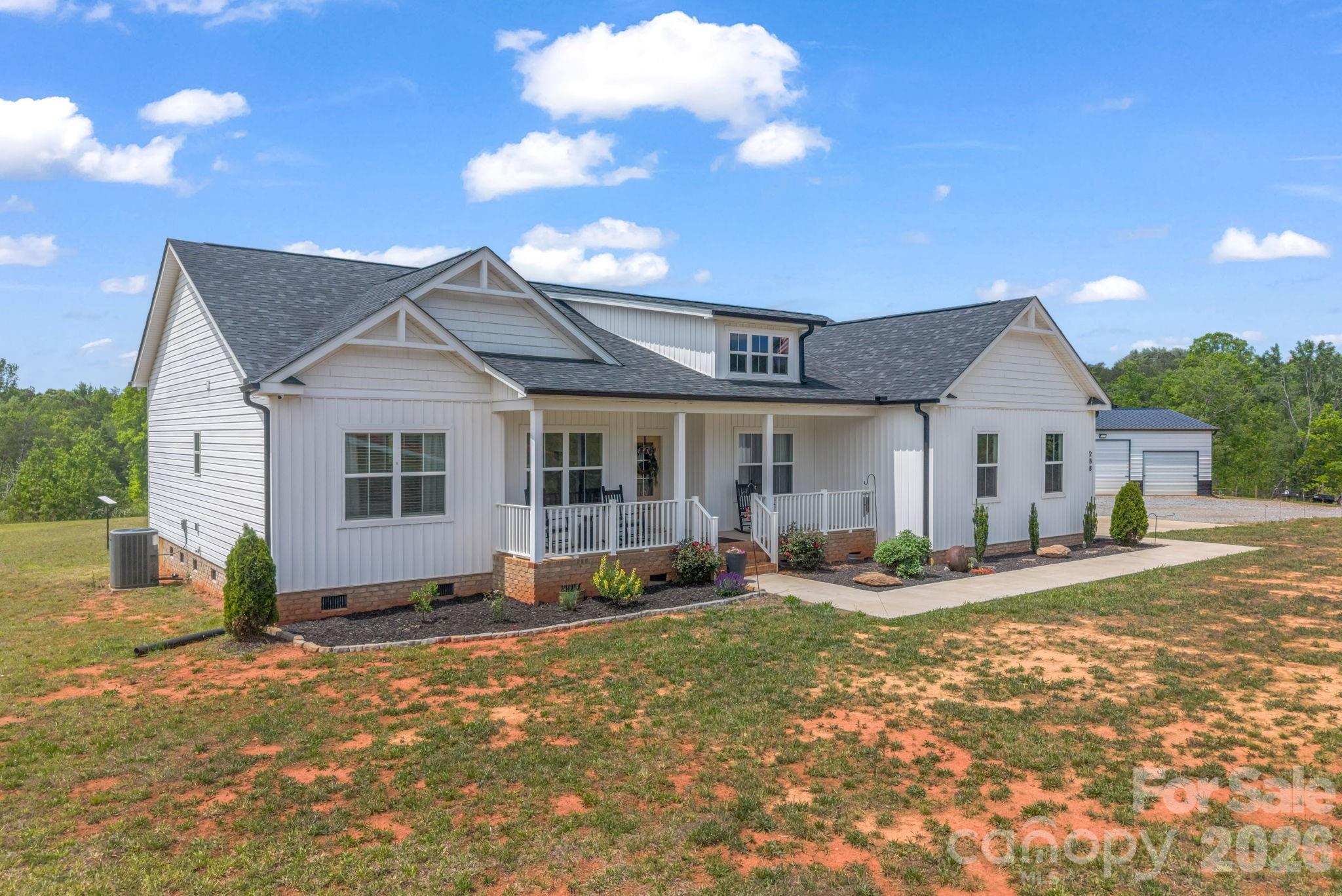 288 Maypole Court Forest City, NC 28043 - Photo 3 of 47 a front view of a house with a yard outdoor seating and garage