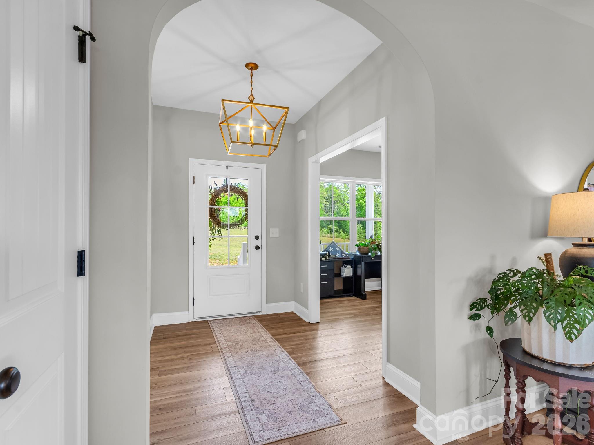 288 Maypole Court Forest City, NC 28043 - Photo 4 of 47 a view of an entryway with wooden floor and a chandelier