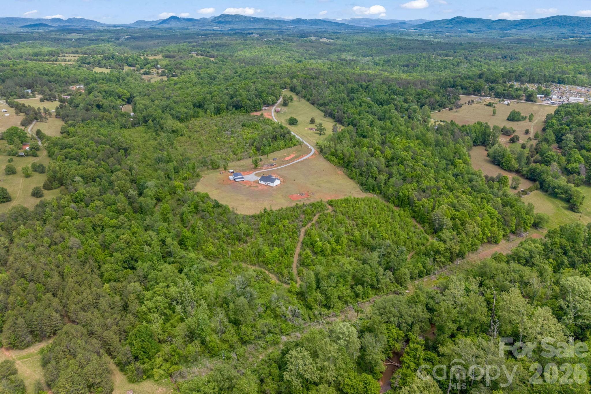 288 Maypole Court Forest City, NC 28043 - Photo 46 of 47 a view of a lush green field with lots of bushes