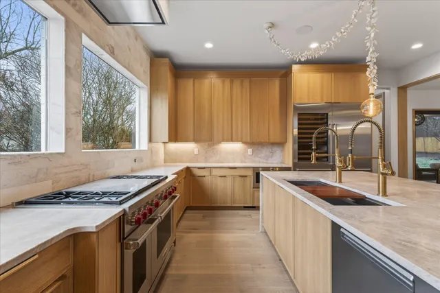 a kitchen with a sink stove top oven and refrigerator