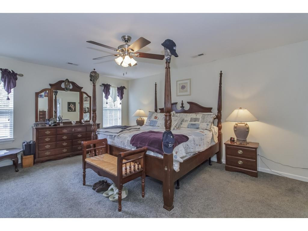 1223 Maple Burlington, NC 27217 - Photo 14 of 24 a bedroom with furniture and a chandelier