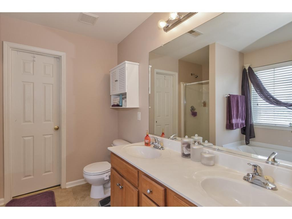 1223 Maple Burlington, NC 27217 - Photo 16 of 24 a bathroom with a sink vanity granite toilet and a mirror