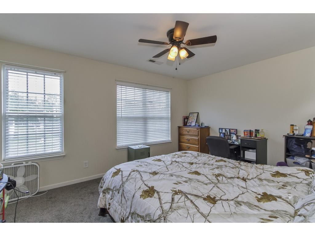 1223 Maple Burlington, NC 27217 - Photo 20 of 24 a bedroom with a bed and a chandelier