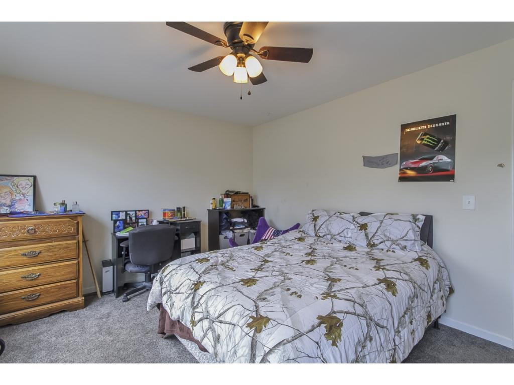 1223 Maple Burlington, NC 27217 - Photo 21 of 24 a bedroom with a bed and a chandelier