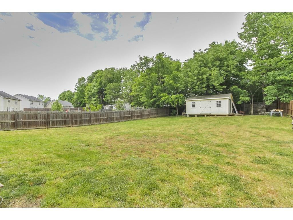1223 Maple Burlington, NC 27217 - Photo 23 of 24 a view of a swimming pool and trees in the background