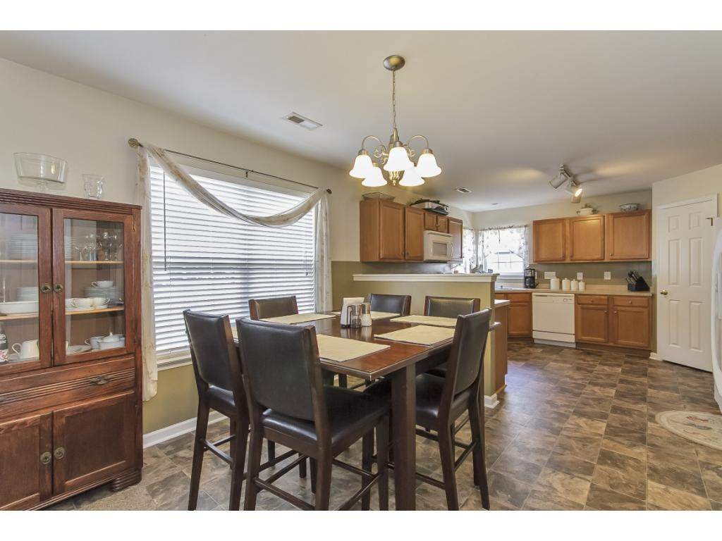 1223 Maple Burlington, NC 27217 - Photo 6 of 24 a view of a dining room with furniture and chandelier