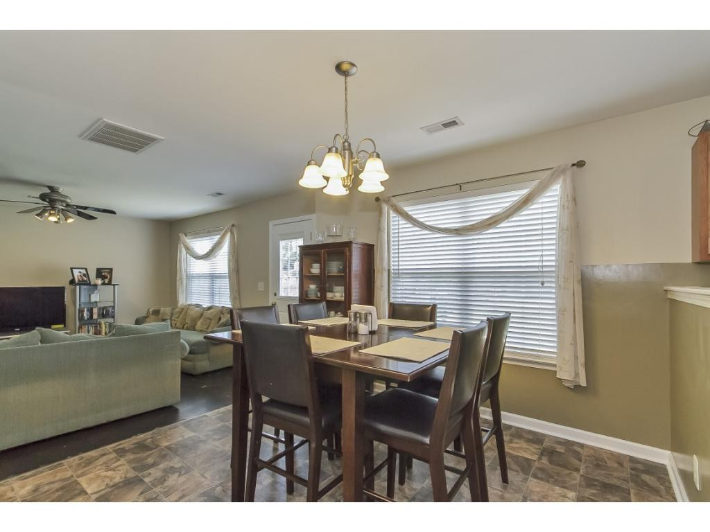 1223 Maple Burlington, NC 27217 - Photo 7 of 24 a dining room with a wooden table and chairs