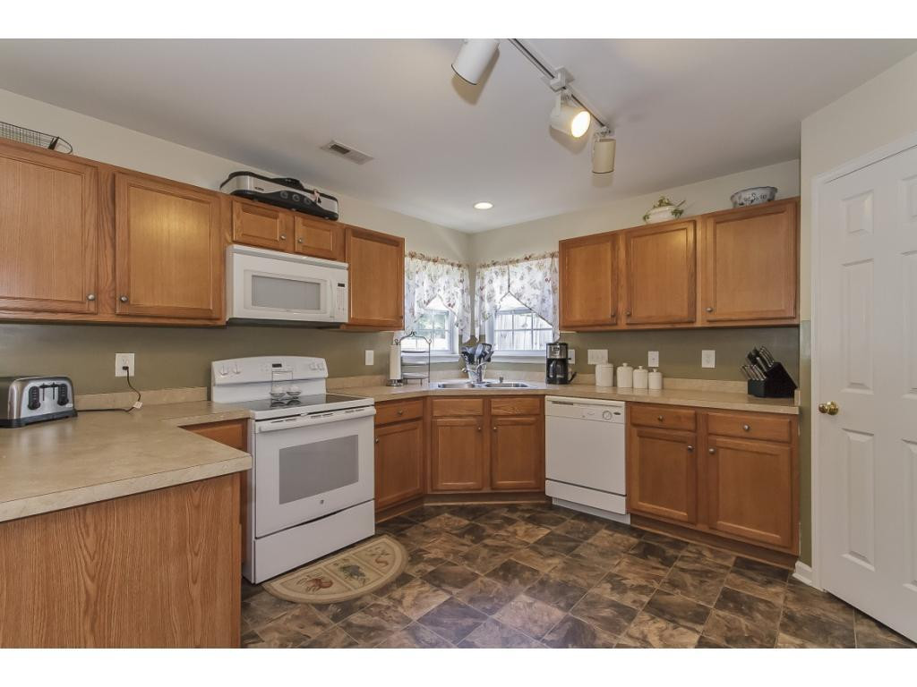 1223 Maple Burlington, NC 27217 - Photo 8 of 24 a kitchen with sink cabinets and window