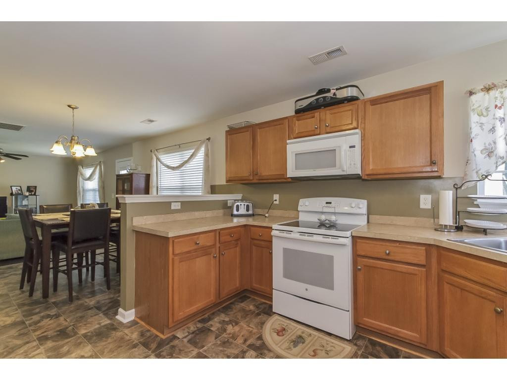 1223 Maple Burlington, NC 27217 - Photo 9 of 24 a kitchen with a sink stove and cabinets