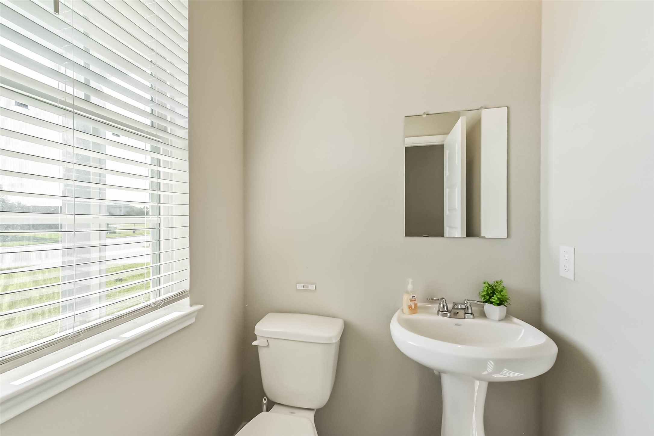4907 Luke Matthew Drive Rosharon, TX 77583 - Photo 17 of 42 a bathroom with a toilet sink and mirror