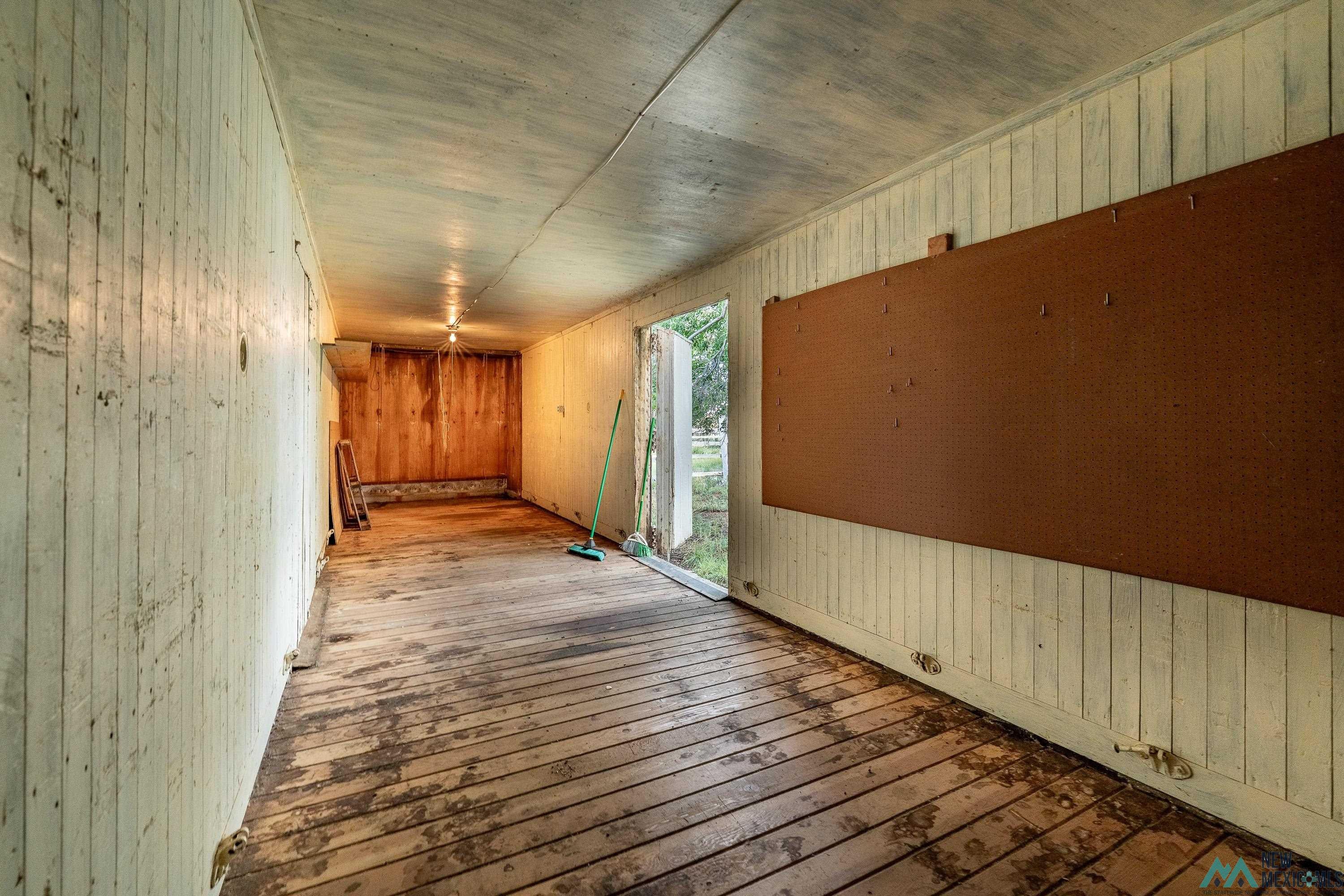 35234 Highway 87 Raton, NM 87740 - Photo 79 of 90 Empty room featuring wooden walls and wood-type flooring