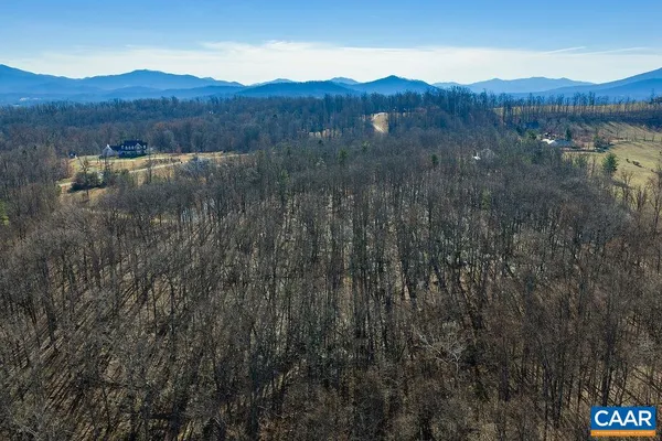 a view of mountains and a field