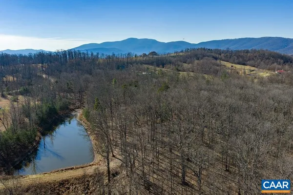 a view of a lake in middle of the forest