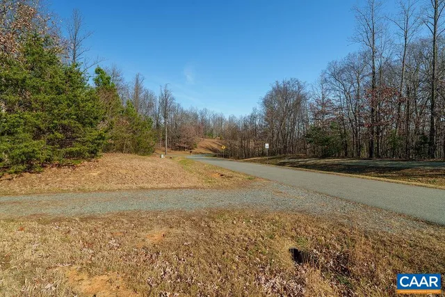 a view of dirt yard with trees