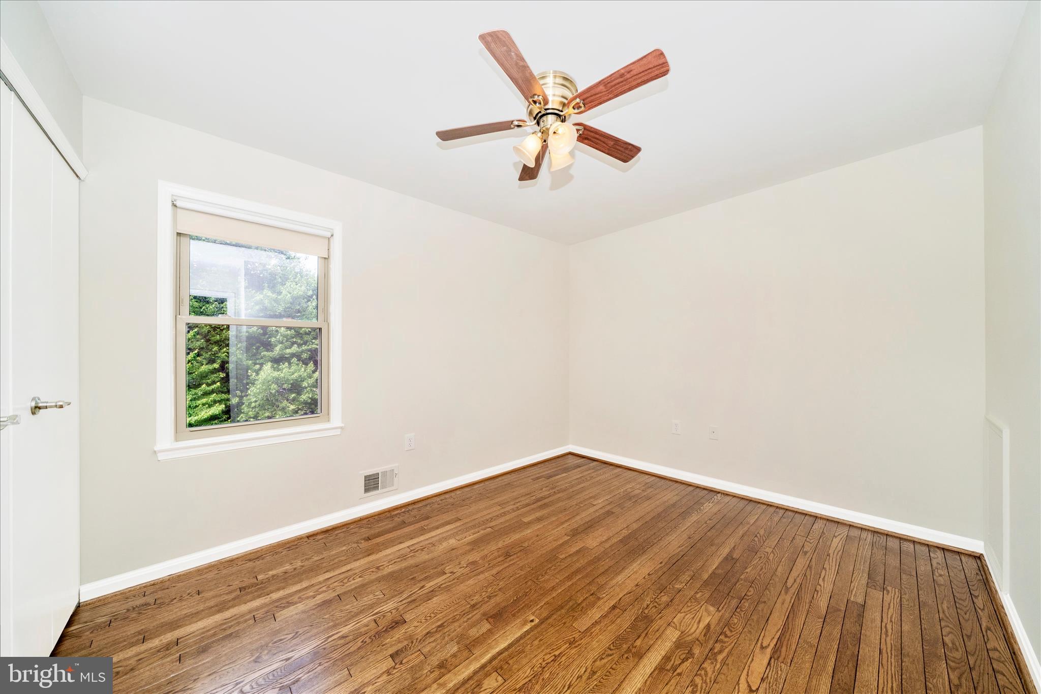 16000 Narrows Terrace Silver Spring, MD 20906 - Photo 28 of 54 an empty room with wooden floor fan and windows