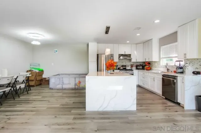 a living room with furniture and a fireplace with wooden floor