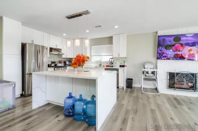 a kitchen with a white cabinets and refrigerator