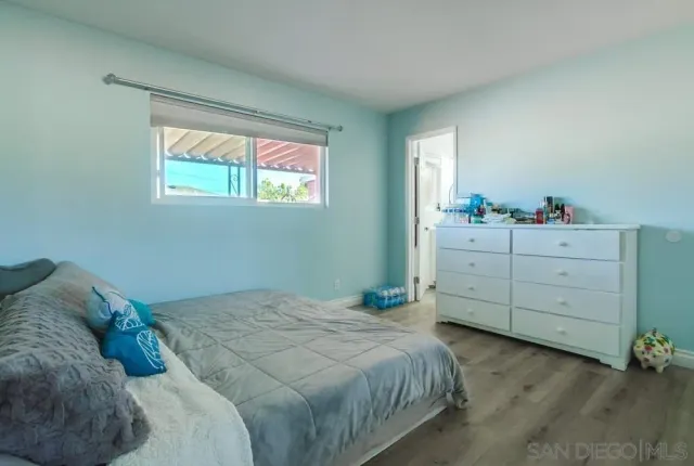 a bathroom with a toilet sink vanity and mirror