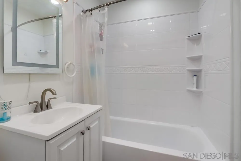 634 Daisy Street Escondido, CA 92027 - Photo 34 of 57 a bathroom with a bathtub a shower a sink and a mirror