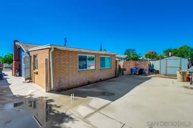 a kitchen with stainless steel appliances granite countertop a stove a refrigerator and a dining table with wooden floor