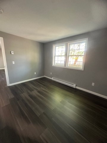 15-17 Otis Court, Unit 15 Springfield, MA 01119 - Photo 8 of 16 an empty room with wooden floor and windows