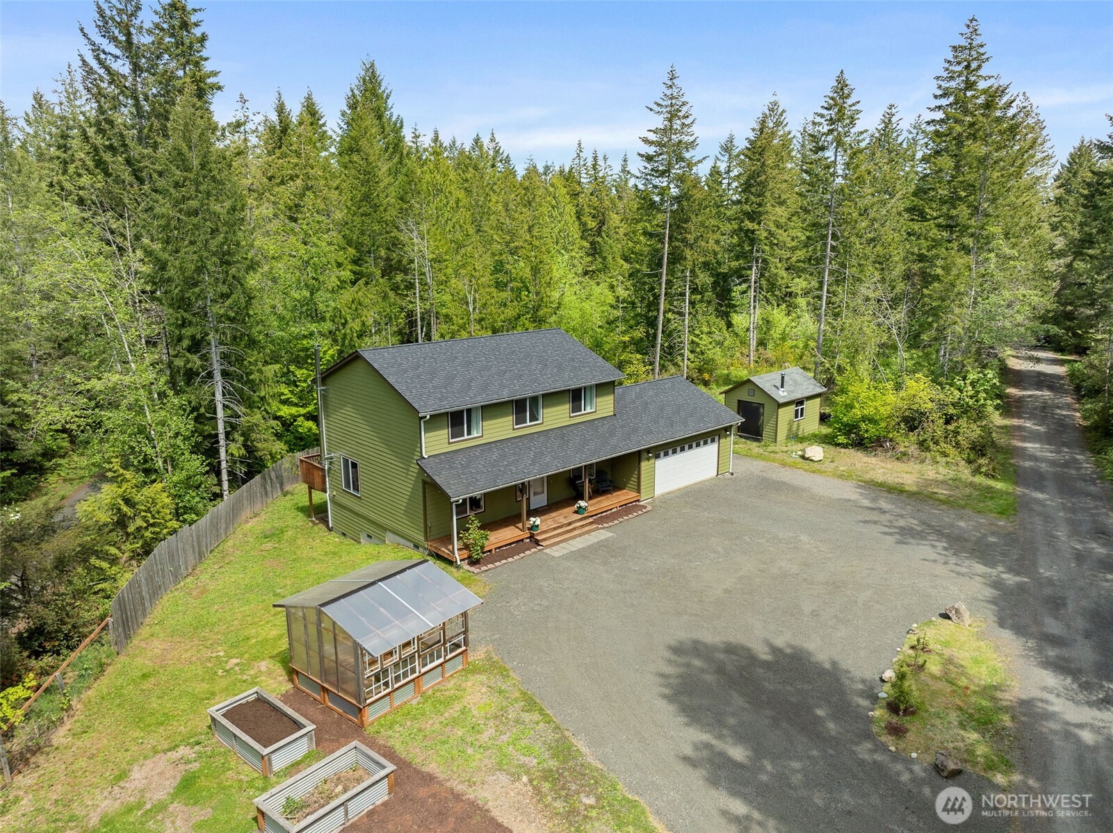 401 East Sunset Ridge Road Union, WA 98592 - Photo 29 of 37 an aerial view of a house with swimming pool and trees in the background