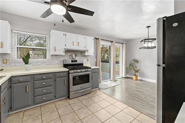 a kitchen with stainless steel appliances granite countertop a stove a sink and a refrigerator