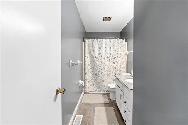 a view of a bathroom with tub and shower