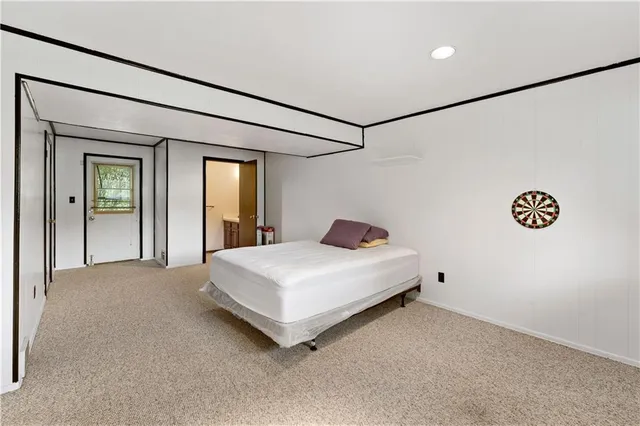 a spacious bedroom with a bed and a table
