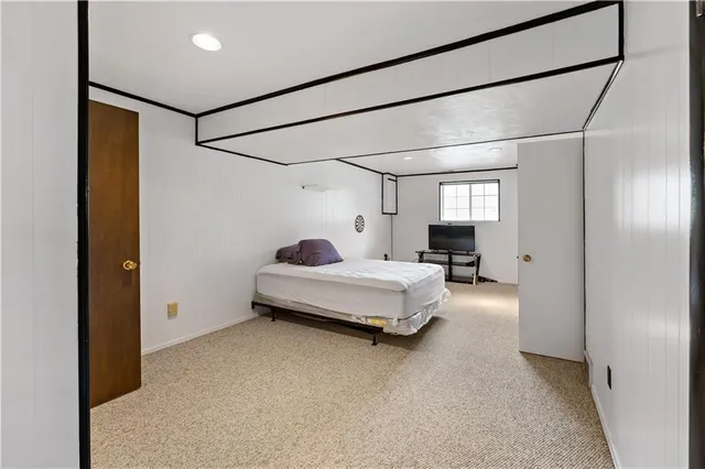 a bedroom with bed and window