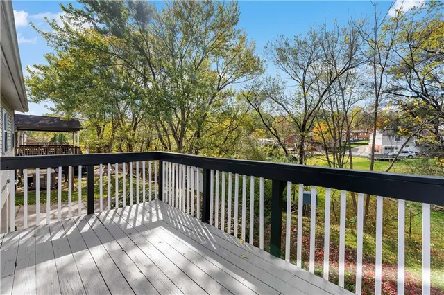 a view of balcony with wooden floor and fence