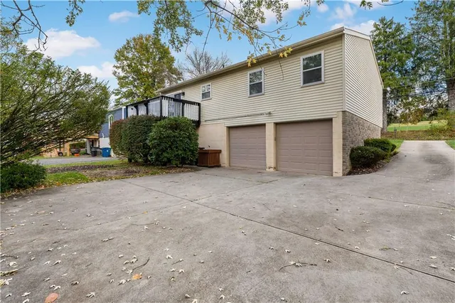 a view of a house with a yard and garage