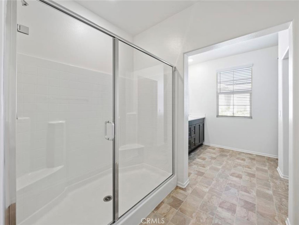 30360 Town Square Drive Menifee, CA 92584 - Photo 16 of 26 a bathroom with a shower and a glass door