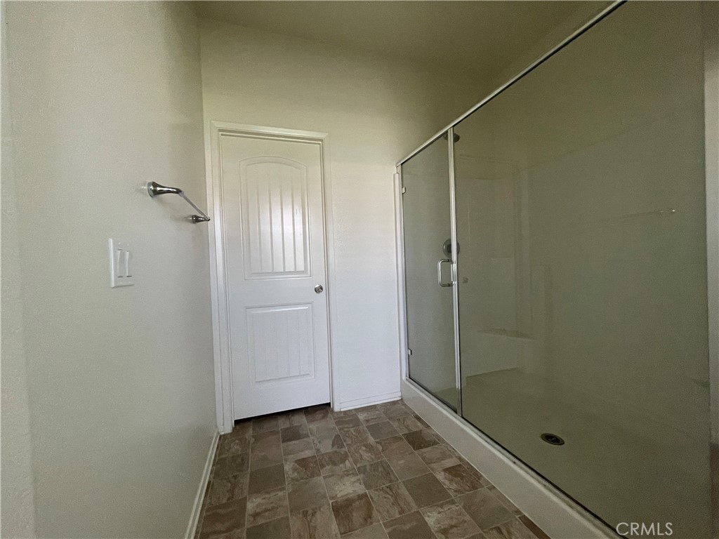 30360 Town Square Drive Menifee, CA 92584 - Photo 17 of 26 a bathroom with a glass door shower