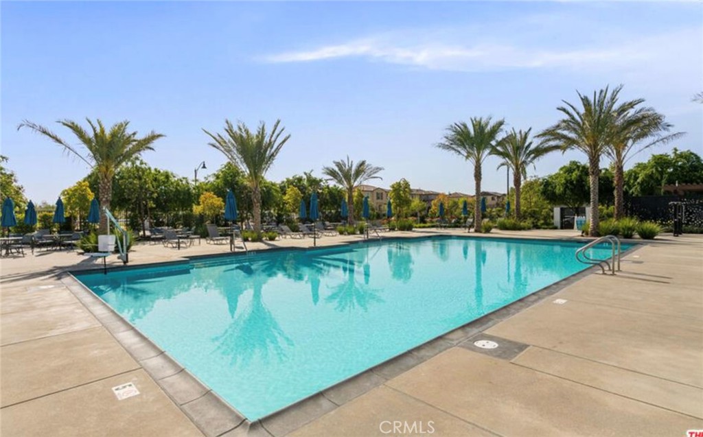 30360 Town Square Drive Menifee, CA 92584 - Photo 25 of 26 a view of a swimming pool with a lawn chairs and palm trees