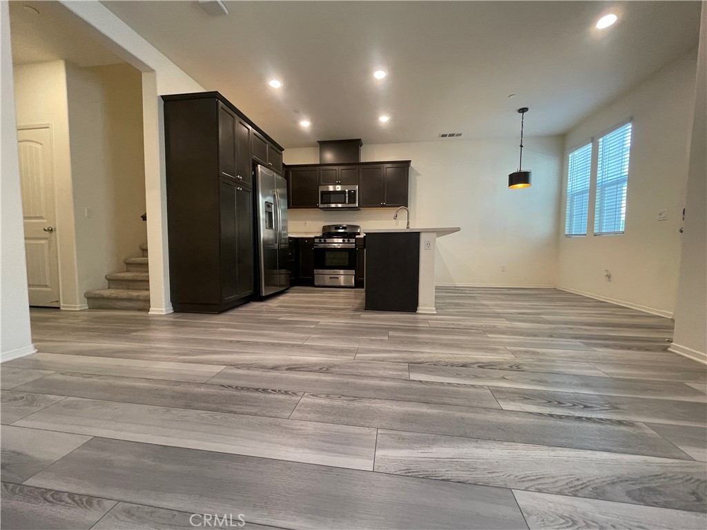 30360 Town Square Drive Menifee, CA 92584 - Photo 6 of 26 a view of kitchen with stainless steel appliances kitchen island