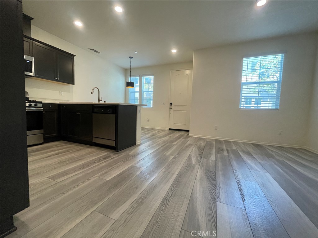 30360 Town Square Drive Menifee, CA 92584 - Photo 7 of 26 a living room with a flat screen tv and wooden floor