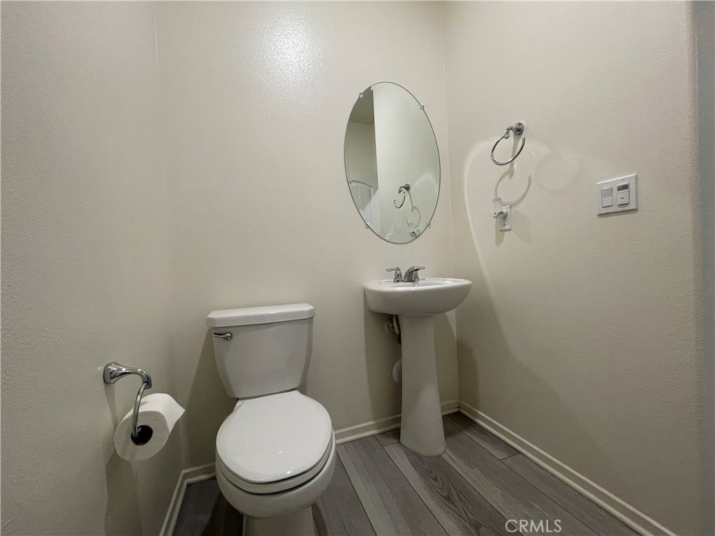 30360 Town Square Drive Menifee, CA 92584 - Photo 10 of 26 a bathroom with a toilet sink and mirror
