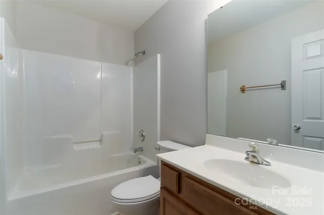 a view of backyard with wooden fence and large trees