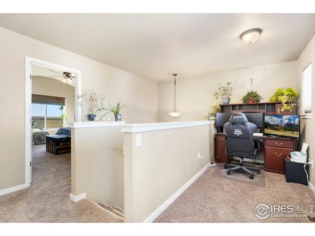 a living room with furniture and a dining table